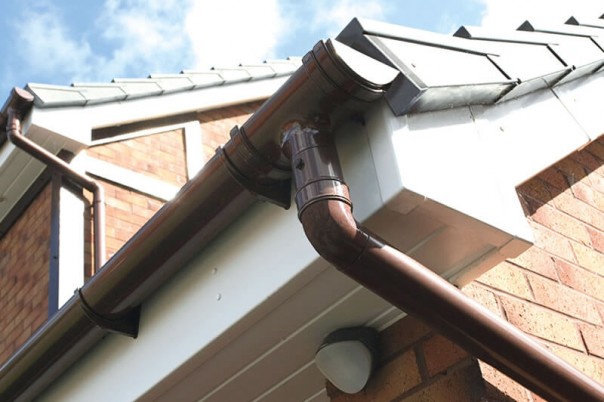 Brown roof guttering and down pipe