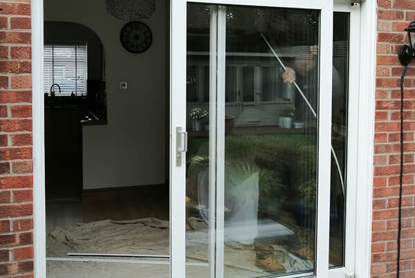 Old UPVC patio out and installe anthracite grey aluminium bifold doors